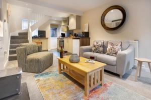 a living room with a couch and a table at Garn Yam Cottage in Ambleside