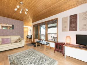 a living room with a couch and a tv at Chalet No 2 in Skipton