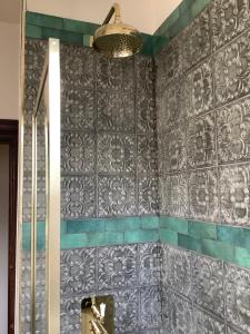 a bathroom with a gray wall with a mirror at Rooms or Entire City House 6min drive to Stadium of Light in Sunderland +109 photos