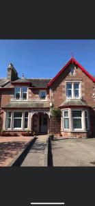 a large brick house on a street at Inchrye Bed & Breakfast in Inverness