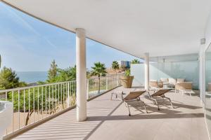 balkon z krzesłami i widokiem na ocean w obiekcie Stylish apartment with oceanview w Maladze