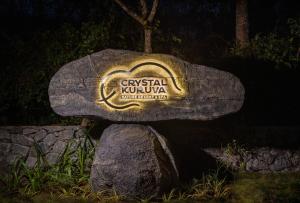 a sign on a rock in the dark at Crystal Kuruva Nature Resort & Spa in Wayanad