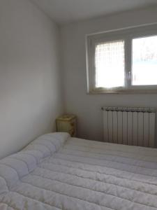 Un pat sau paturi într-o cameră la Appartamento Diana