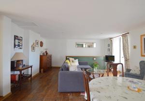 a living room with a couch and a table at Joli Canard in Badefols-dʼAns