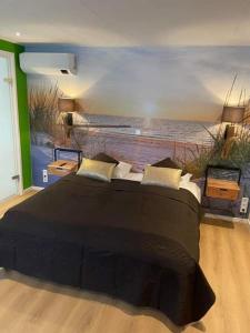 a bedroom with a large bed with a painting on the wall at De Vier Seizoenen in Renesse
