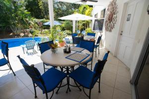 a patio with a table and chairs and a pool at The Hideaway Hotel in Sámara