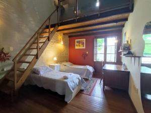 a bedroom with two beds and a staircase at Espectacular Casa !Inmejorable ubicación in Salto