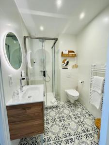 a bathroom with a shower and a sink and a toilet at La Caravelle Logis in Biscarrosse