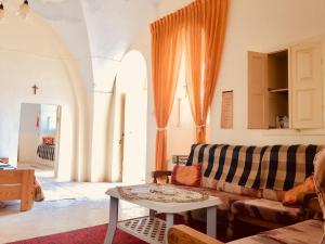 a living room with a couch and a table at Traditional House with Amazing Veranda in Bethlehem