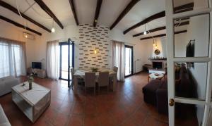 a living room with a couch and a table at MANDALA HOUSE in Afissos