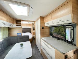 a view of the living room and kitchen of a caravan at Mietwohnwagen 02 in Heringsdorf