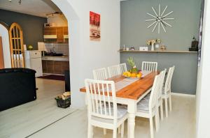 a kitchen and dining room with a wooden table and chairs at Lola's House in Jajce