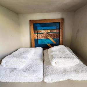 two beds in a room with a painting on the wall at CASA MARGARITA 1Piso Monoambiente in San Salvador de Jujuy
