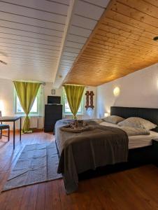 a bedroom with a large bed and a wooden ceiling at Gästehaus Pension Romantika in Cochem