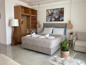 a bedroom with a bed and a living room at Wide Blue Luxury Boutique Suites in Neos Marmaras