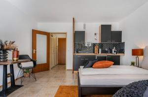 Un dormitorio con una cama y una mesa y una cocina. en Kurzzeitglück 24h Self Check-In MG01, en Mönchengladbach