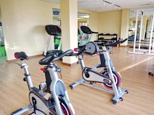 a gym with several exercise bikes in a room at JCM- Studio Deluxe Room in Manila