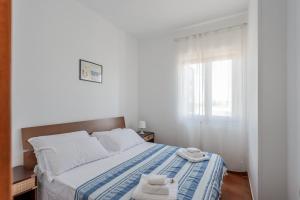 Postel nebo postele na pokoji v ubytování Portobello sul mare by Rentbeat