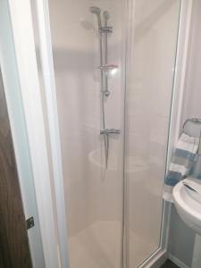 a shower stall in a bathroom with a sink at Beautiful 8 Berth Caravan At Wild Duck Haven Park In Norfolk Ref 11195sc in Great Yarmouth