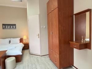 a hotel room with a bed and a closet at Garden Vila in Vrnjačka Banja