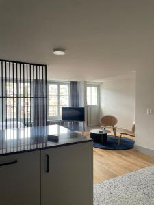 a kitchen and living room with a table and a couch at La Sauvage in Fribourg