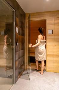 a woman in a white dress standing in a elevator at Holiday Suites Zeebrugge in Zeebrugge