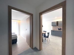 a room with a door leading to a bedroom with a table at PATIO APARTAMENTY in Łagów +30 photos