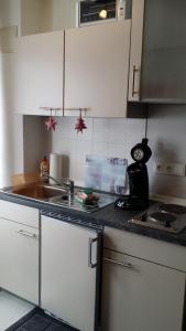 a kitchen with a sink and a counter top at Apartment Gosch an der Skiwiese in Braunlage