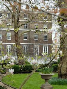 a large brick building with a vase in a park at Stunning Marylebone apartment in London