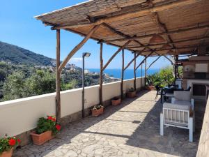 a covered patio with a view of the ocean at Relais Cannavacciuolo in Vico Equense