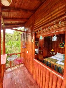 a room with a bed and a table on a balcony at La Bota del Gigante in Gigante