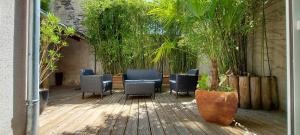 a patio with chairs and a table and plants at Les Suites Angevines in Angers