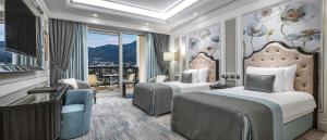 a hotel room with two beds and a balcony at Merit Royal Diamond Hotel & SPA in Kyrenia