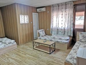 a living room with two beds and a coffee table at Bali Petrich in Petrich