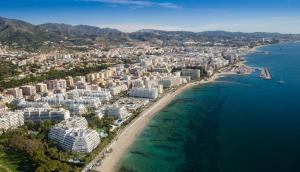 an aerial view of a beach with buildings and the ocean at Marbella Center Apartment in Marbella