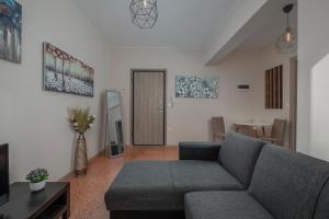 a living room with a couch and a table at Kosmos Service Apartment Absolute City Center 1-5 With Additional Cost Parking in Thessaloniki