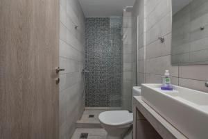 a bathroom with a toilet and a sink and a shower at Kosmos Service Apartment Absolute City Center 1-5 With Additional Cost Parking in Thessaloniki