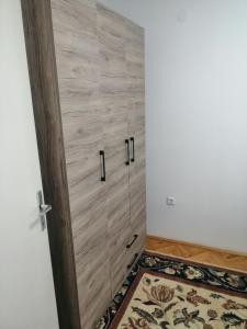 a wooden door in a room with a rug at STE-FI APARTMANS in Gostivar