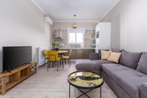 a living room with a couch and a tv at HOUSE ANNA MARIA 2 in Mantoúkion