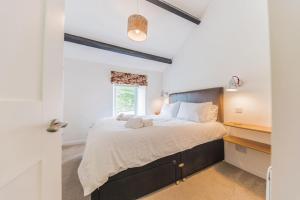 a bedroom with a large bed and a window at Fellside Cottage Coppermines Valley in Coniston
