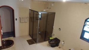 a bathroom with a shower and a sink at Arraial do Cabo - Suite master in Arraial do Cabo +4 photos