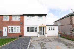 a large white house with a driveway at Lancashire Living! in Preesall