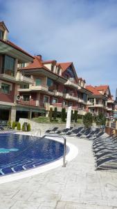 a swimming pool in front of a large building at Hotel Marítimo Ris con garaje in Noja