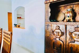 a wooden cabinet with faces on it in a room at Dolce Vita Caribe Villas in Playa del Carmen