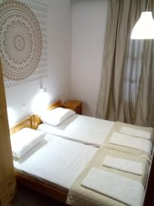 two twin beds in a room with a window at Studios Thomas in Limenaria