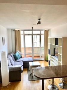 a living room with a couch and a table at Piso bonito con vistas Negreira in Negreira