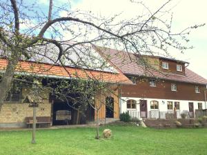 a house with an orange roof on a yard at Holstein-Höfle, Rindalphorn in Argenbühl