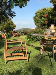 a table and a chair sitting next to a table and a table and chairs at Amazing 4-Bed Cottage lost in Montseny Nature in Arbúcies