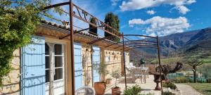 a house with a balcony with a view of mountains at Mas Tulipe de Soie in Bevons