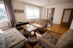 a living room with a couch and chairs and a table at Markeeto apartments in Ilijaš